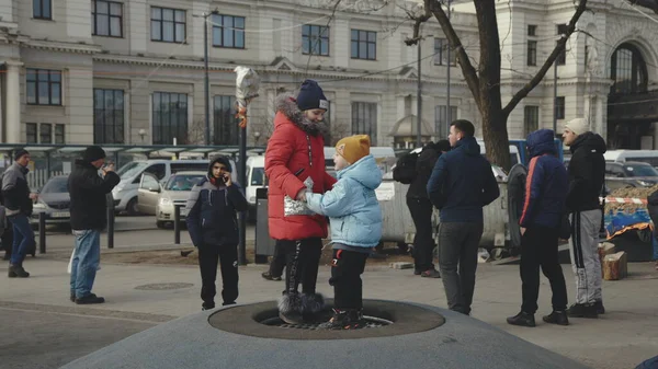 Lviv, Ukrayna - 15 Mart 2022: Ukrayna 'nın batısındaki Lviv kentindeki tren istasyonu yakınlarındaki doğu Ukrayna' dan tahliye edilenler. Sokakta oynayan küçük kızlar.
