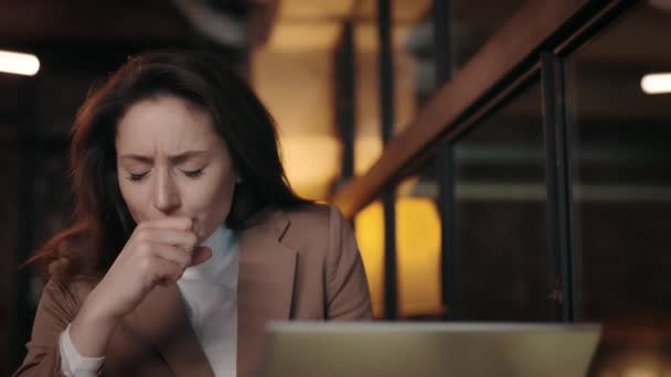 Sick business woman with modern laptop coughing at cozy cafe — 비디오