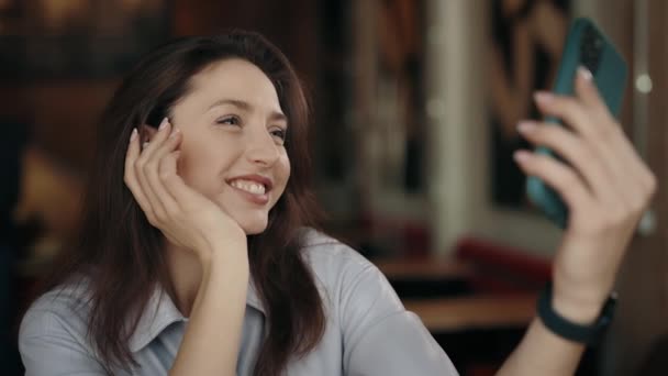 Joyful woman taking selfie on smartphone at cafe — 비디오