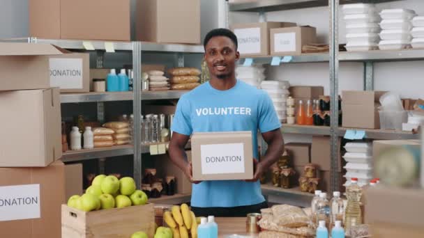 Handsome african american man holding donation box — Video