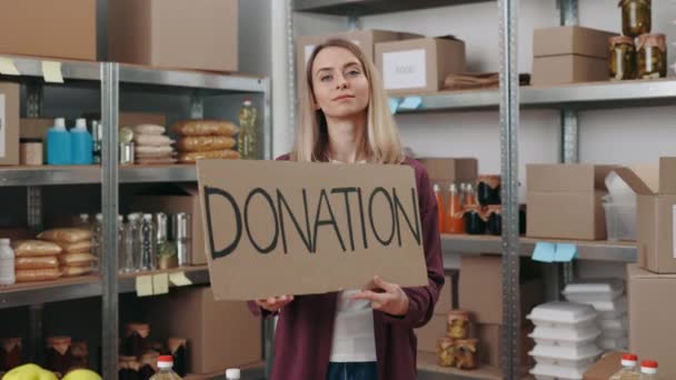 Woman holding banner with text thank you and donation — Video