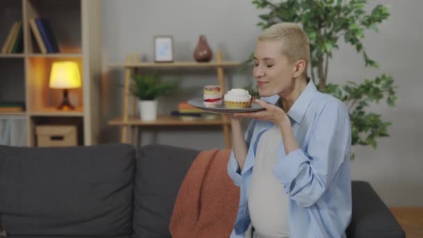 Young Pregnant Woman Suffering Nausea Smelling Cupcakes Plate Home Expectant — Stock Video