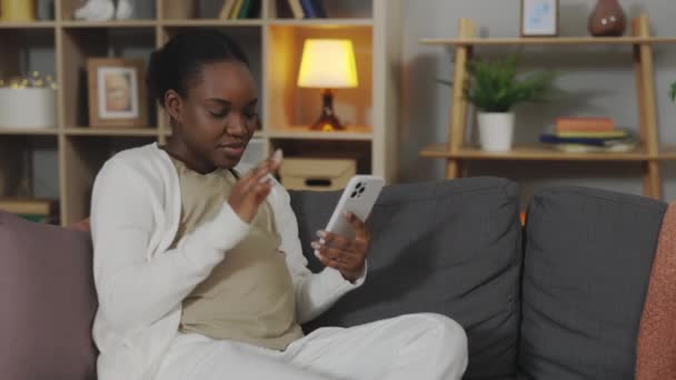 African American Woman Expectation Headache Sitting Sofa Using Modern Smartphone — Stock Video