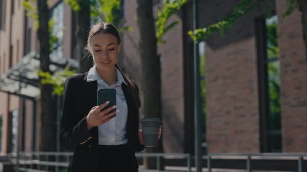 Successful Smiling Woman Holding Cardboard Cup Takeaway Coffee Using Smartphone — Stockvideo