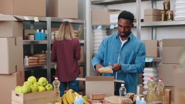 Handsome African American Man Standing Warehouse Putting Food Cardboard Boxes — Stock Video