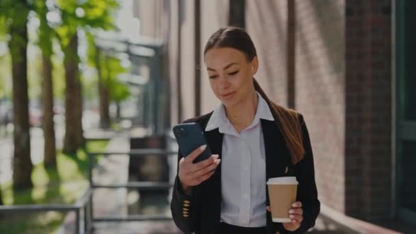 Adorable Caucasian Woman Drinking Her Morning Coffee Using Modern Smartphone — Stockvideo