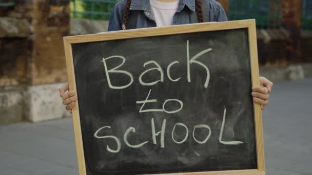 Hands Little Girl Standing Holding Raising Schoolboard Text Back School — Vídeos de Stock