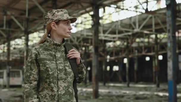 Caucasian Female Soldier Walking Destroyed Manufactory War Looking Woman Backpack — 图库视频影像