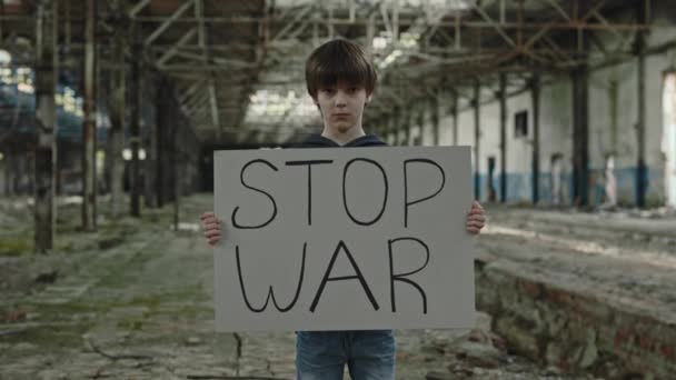 Caucasian School Aged Boy Stop War Banner Hands Standing Destroyed — Video Stock