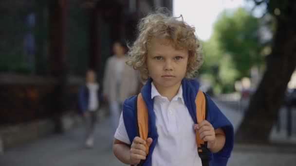 Portrait Little Schoolboy Backpack Standing School Yard Holding Bag Turn — стоковое видео