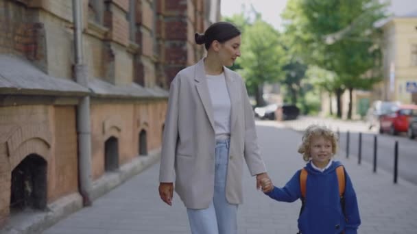 Young Mother Holding Her Son Hands Talking Leads Child School — Stok video