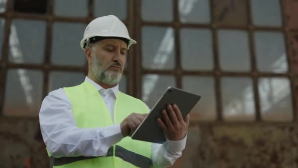 Mature Bearded Inspector Reflective Vest Checking Construction Status While Using — Stock Video