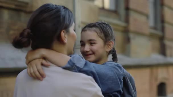 Young Mother Embraces Daughter Backpack Carrying Her His Arms Home — Stok video