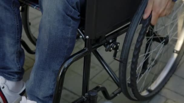 Close Disabled Person Wheelchair Close View Disabled Mans Hand Pushing — Stockvideo