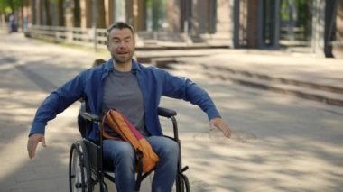 Disabled father having fun with his son after school. Disabled dad having fun with his son while spending time together. Happy man raising arms and having fun. Family and disabled people concept