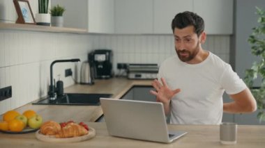 Online Marriage Proposals. Happy man doing the proposal online using the laptop and showing the red ring box to the camera and feeling cherfull about answer. People relationship concept