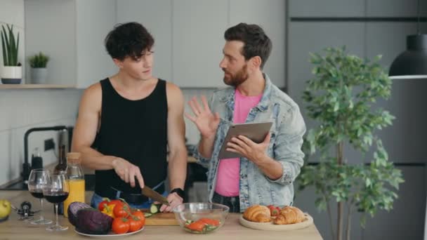 Lgbt Couple Standing Together New Apartment Kitchen Cooking One Partner — Vídeos de Stock