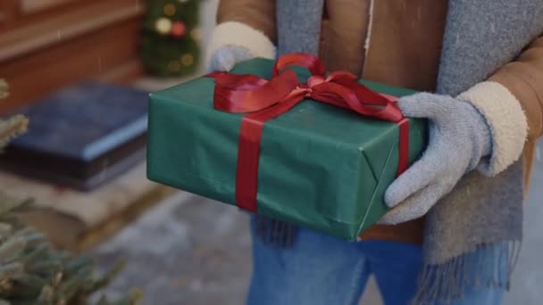 Mans Hands Gloves Holding Big Christmas Gift Red Ribbon While — Stock Video