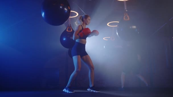 Strong Athletic Woman Hitting Boxing Bag Wearing Red Gloves Man — Stock Video