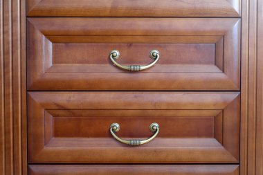 Brown cupboard with two drawers inside a house
