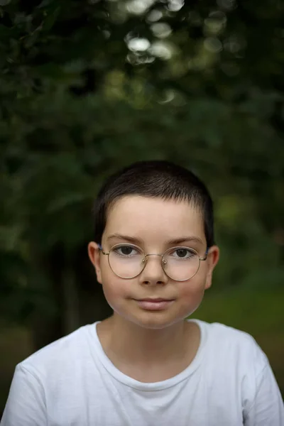 Portrait of a teenage girl with glasses in the woods in Poland