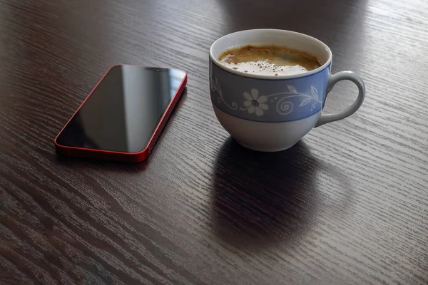 Red Mobile Phone Lying Wooden Table Next Cup Coffee — Stock Photo, Image