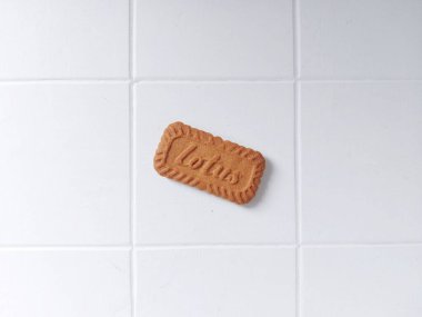 Lotus biscoff bisküvileri. Virüslü atıştırmalıklar. Tadı çok güzel. Genellikle tatlılarda süs olarak kullanılır. Karamelli ve çıtır çıtır. Beyazlar içinde izole edilmiş bir arka plan. Üst Manzara. Flatlay fotoğrafçılık. Neşeli bir ruh hali