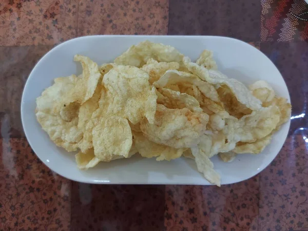 揚げチップだ メランジョ豆から作られた おいしいですね インドネシアの伝統的な軽食 白い皿に盛り付け — ストック写真