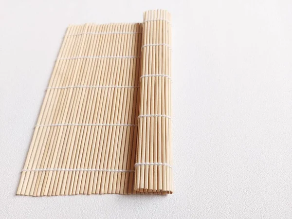 sushi bamboo mat. traditional utensil to make sushi, traditional food from japan. isolated background in white. copyspace.