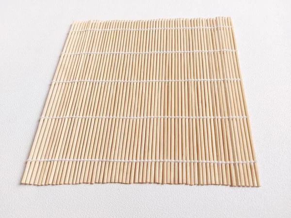 sushi bamboo mat. traditional utensil to make sushi, traditional food from japan. isolated background in white. copyspace.
