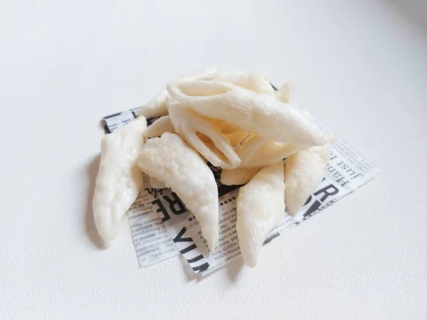 fish chips served on food grade paper. isolated background in white. minimalist and aesthetic photography concept