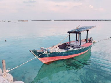 blue wooden boat pulled up on the beach. minimalist photography concept