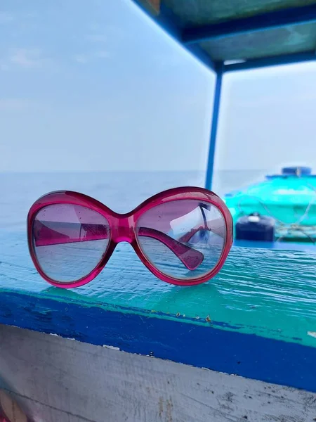 glasses on a wooden boat over the sea
