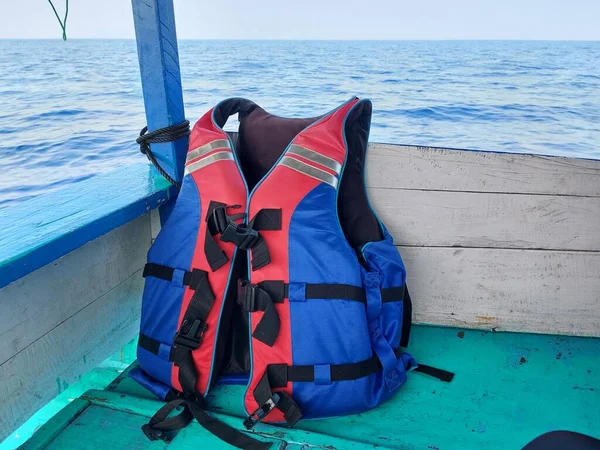 life jacket on a wooden boat over the sea