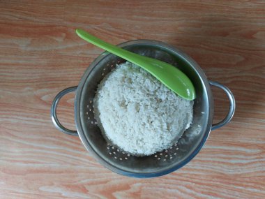 white rice on stainless steel container. isolated background.