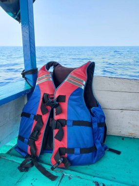 life jacket on a wooden boat over the sea