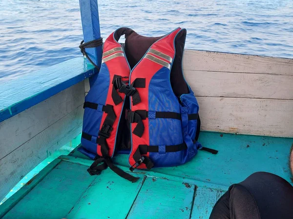 life jacket on a wooden boat over the sea
