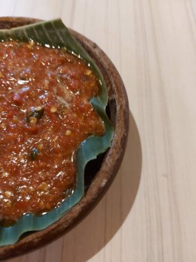 Sambal pecak. It is traditional sauce from indonesia that is usually served with fried foods, such as fried chicken, fish, eggs, eggplant. Served on clay plate. Hot and fresh.