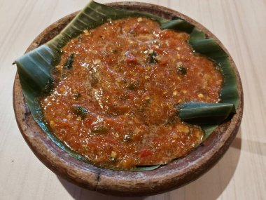 Sambal pecak. It is traditional sauce from indonesia that is usually served with fried foods, such as fried chicken, fish, eggs, eggplant. Served on clay plate. Hot and fresh.