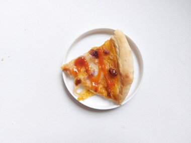 A sliced of pizza on white plate. Isolated background in white