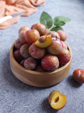 Ahşap kasede erik meyvesi yığını. İzole edilmiş arkaplan