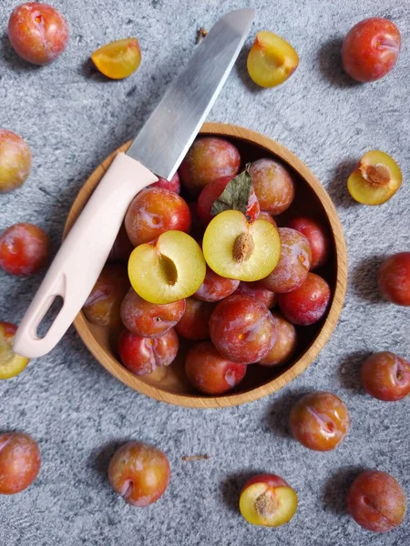 Ahşap kasede erik meyvesi yığını. İzole edilmiş arkaplan