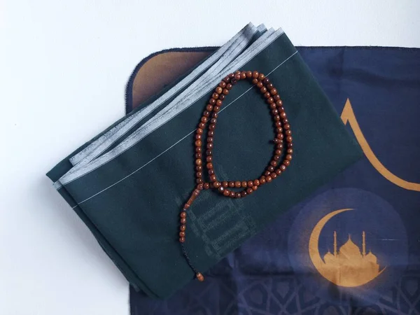 sarongs and prayer mats.  prayer equipment for Muslim men.  isolated background in white