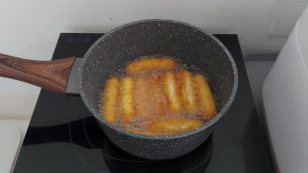 灰色の鍋で鶏のナゲットを揚げ 電気ストーブの上 — ストック動画