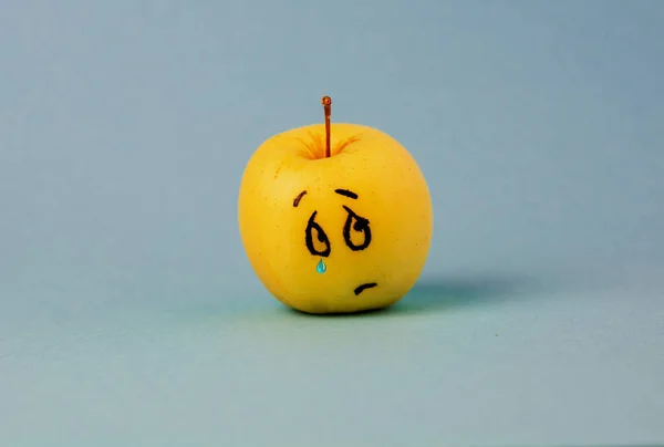 crying sad Face on an apple - abstract image of bad scary human emotions background