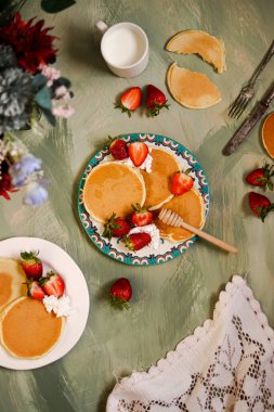 a tabletop photo of pancakes and strawberry clipart