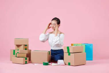 Pembe arka planda başı ağrıyan stresli iş kadını.