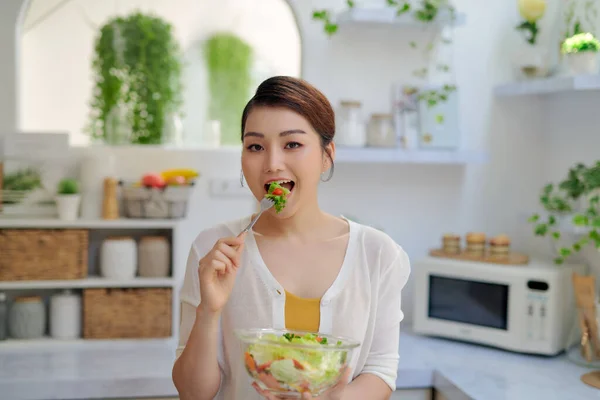 happy sexy woman with salad on white background