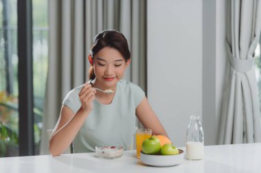 Pretty girl, happy meal eating healthy breakfast in morning,