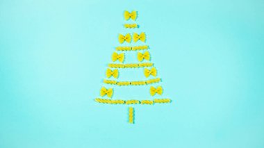 The creative installation show Christmas tree made of pasta.  Concept of christmas celebration and favorite food.